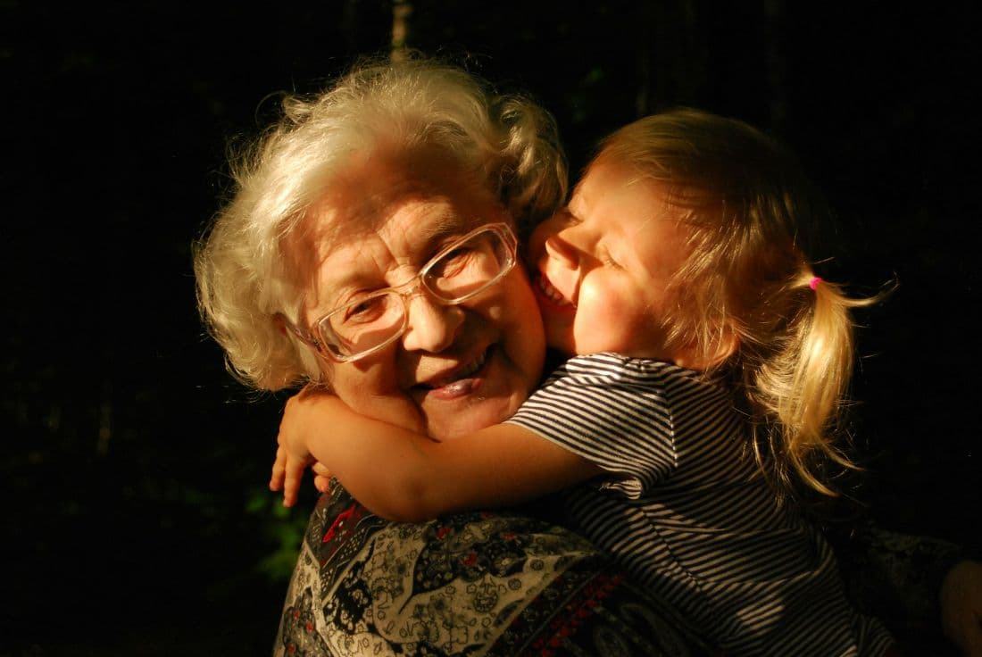 A grandmother hugging her grandchild