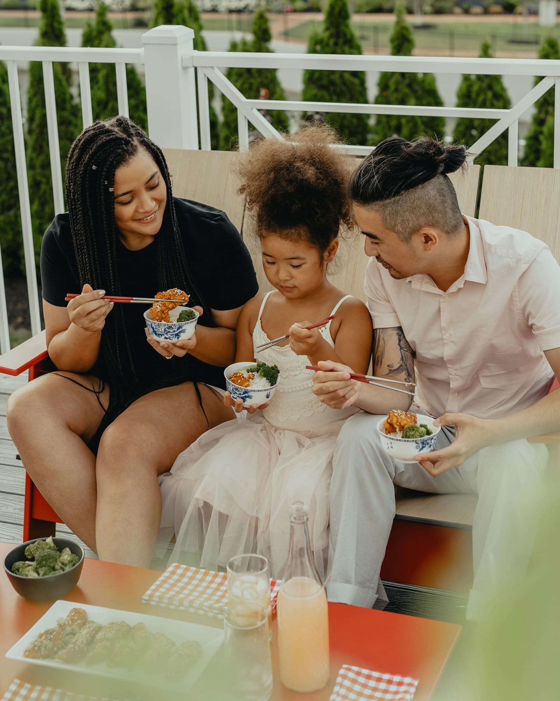 A family sharing food on a patio