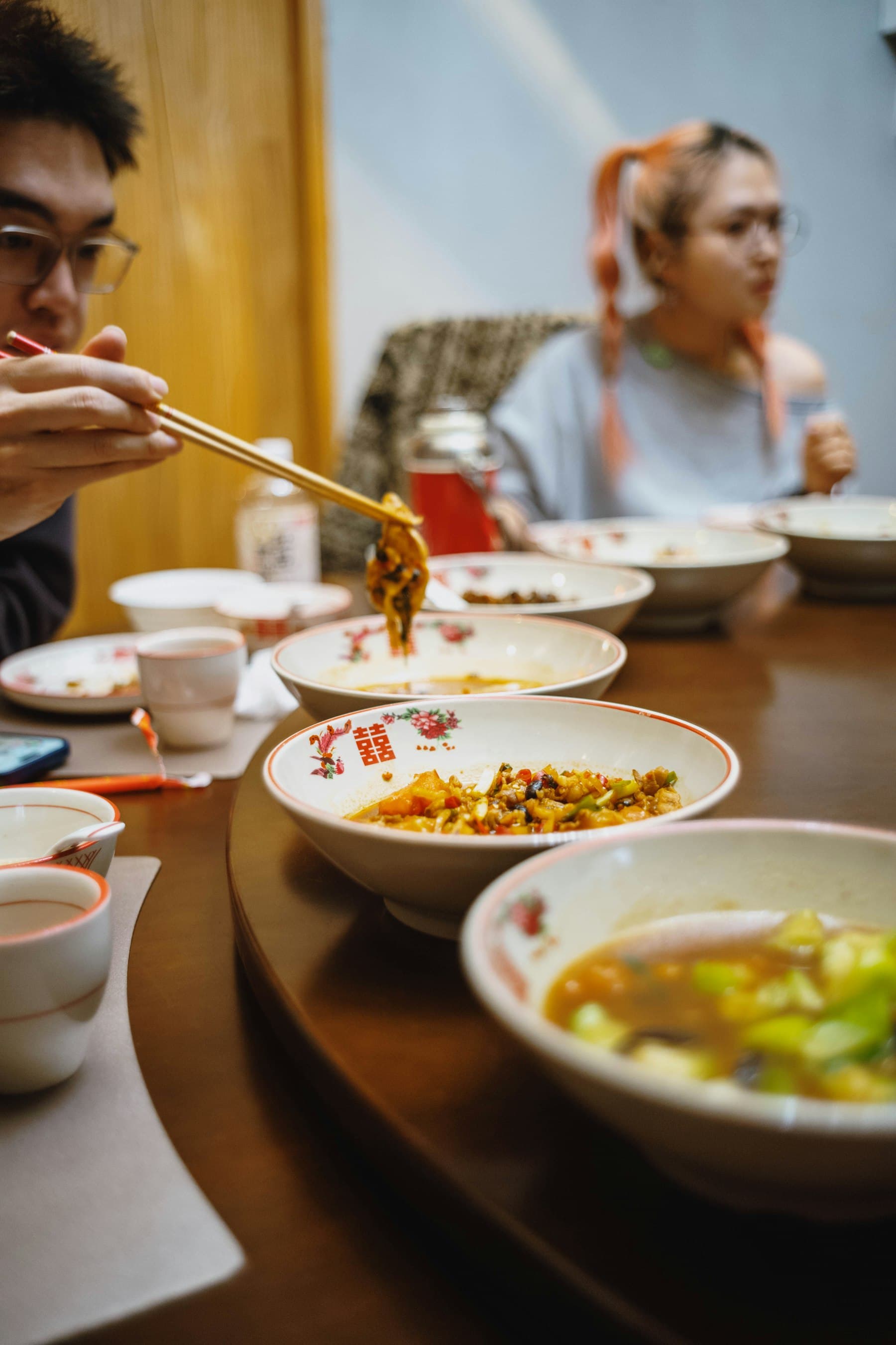 Two people sharing a meal and talking across the table